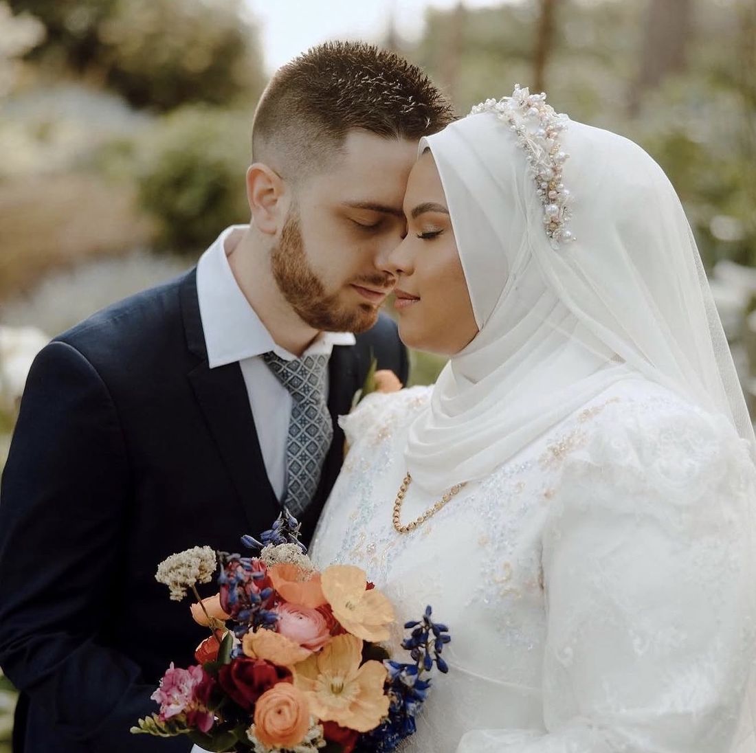 Bride in a pearl-trimmed hijab with a soft, glowing finish