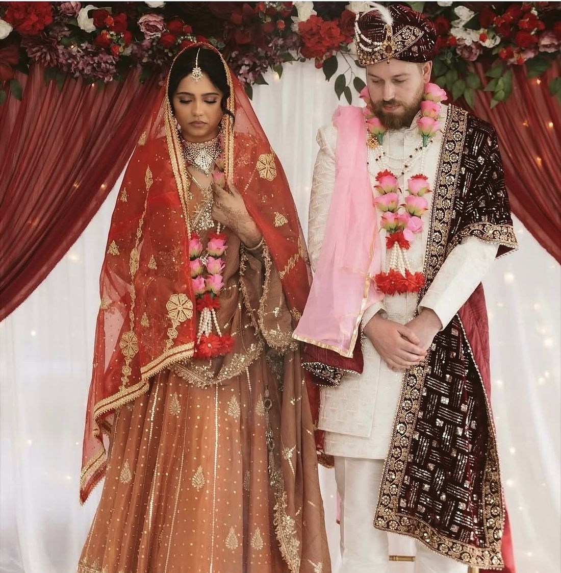 Bride in a red and gold dupatta during her wedding ceremony